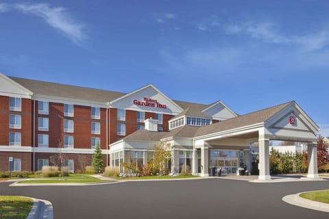 Brick building with covered entrance and landscaped walkway