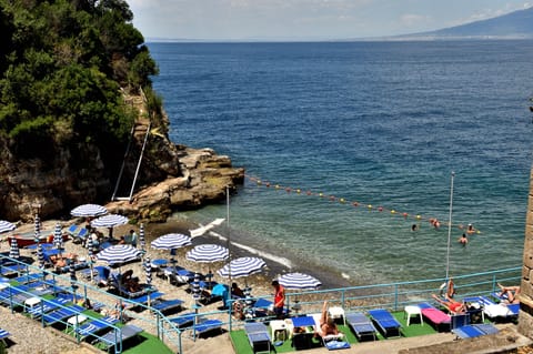 Private beach, black sand, sun loungers, beach umbrellas