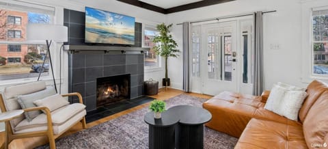 Relax in your stylish living room featuring a cozy fireplace, perfect for unwinding after exploring.