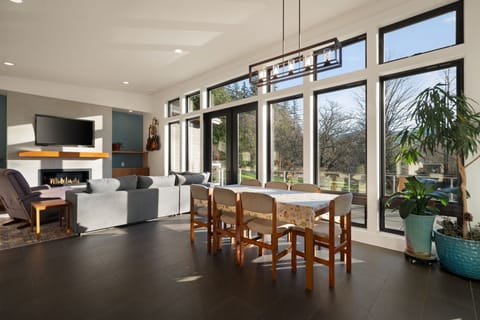 Relax in your bright, modern space where floor-to-ceiling windows frame peaceful garden views and cozy fireplace evenings await.