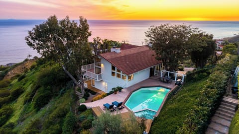 Sunset views over the Pacific with a private pool and hillside setting.