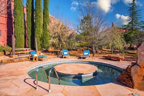 Slide into the heated pool with the spa bubbling behind you — the rocks turn copper at golden hour and stay that color until well after sundown.