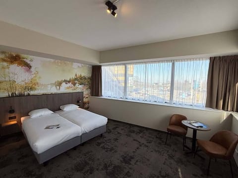 Wake up to city views and morning coffee by the window.