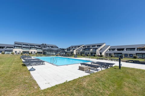 Soak up the open sky from a quiet poolside corner.