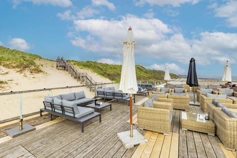 Unwind on the oceanfront deck with breezy umbrella-shaded seating.