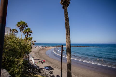 Beach nearby, black sand, sun loungers, beach umbrellas