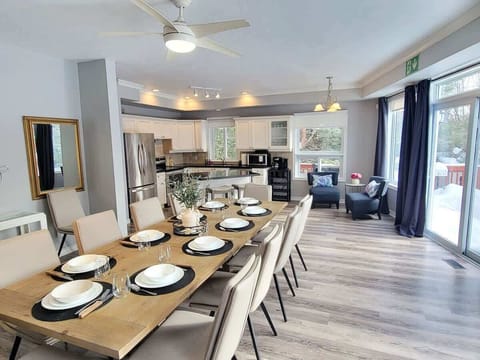 Main Floor Dining room w table sits 14 guests, Kitchen, Coffee area  and walk to the Deck and Hot Tubs