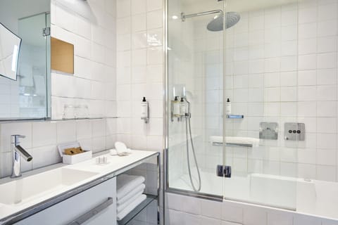 Deluxe Room, 1 King Bed | Bathroom | Rainfall showerhead, designer toiletries, hair dryer, bathrobes