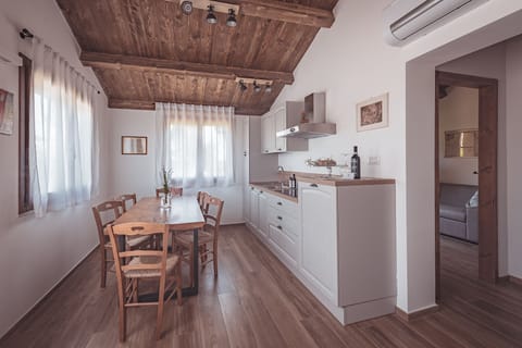 Family Condo, 1 Bedroom, Ground Floor (PIOPPO) | Private kitchen | Full-size fridge, stovetop, cookware/dishes/utensils, dining tables