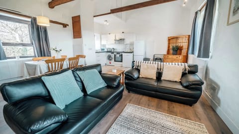 Unwind under original timber beams in our airy, open-plan lounge—ideal for cozy movie nights on the Smart TV or a quiet afternoon with a board game.