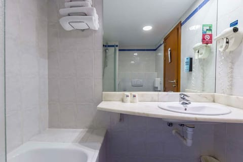 Bathtub, eco-friendly toiletries, hair dryer, towels