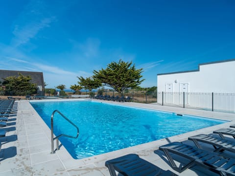 Wide shot of the pool terrace, with lounge chairs and open space for the whole group