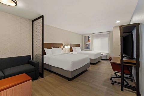 Relax after exploring with beds, workspace, and entertainment in view.