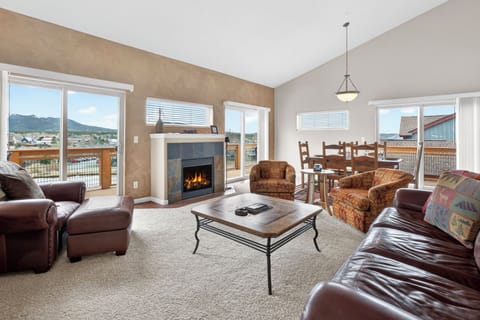 Cozy up by your crackling fireplace in this spacious living room with stunning mountain views and comfortable seating for the whole family.