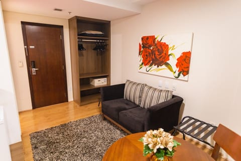 Premium Suite, 1 King Bed | Living area | 32-inch LCD TV with cable channels, TV