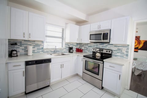 Apartment, 4 Bedrooms | Private kitchen | Full-size fridge, microwave, stovetop, coffee/tea maker