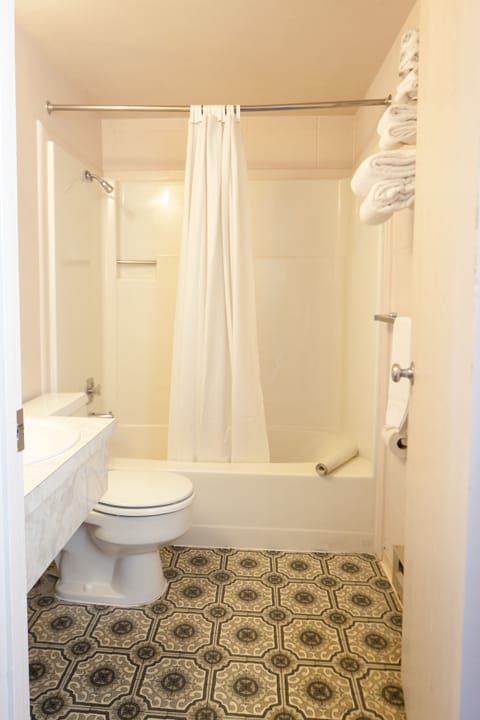 Deluxe Room, 2 Queen Beds | Bathroom | Combined shower/tub, hair dryer, towels