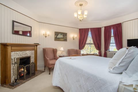 The Crosby Fireplace Room | Premium bedding, blackout drapes, iron/ironing board, free WiFi