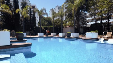 Outdoor pool, open 9:00 AM to 10:00 PM, pool umbrellas, sun loungers