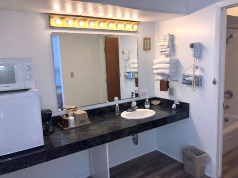 Economy Room, 2 Queen Beds, Balcony | Bathroom | Combined shower/tub, deep soaking tub, free toiletries, hair dryer
