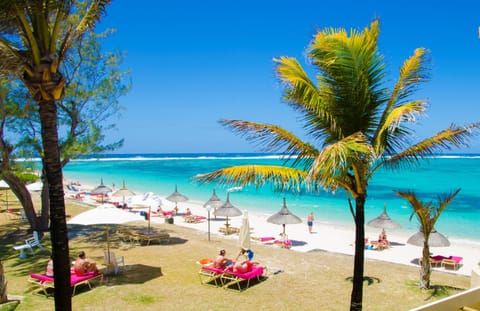 On the beach, white sand, sun loungers, beach umbrellas