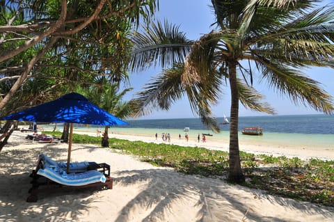 On the beach, white sand, sun loungers, beach umbrellas