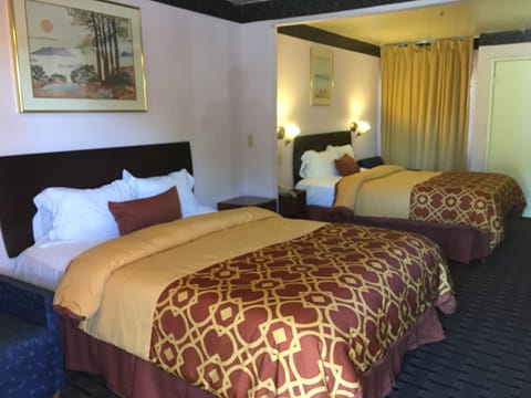 Room, 2 Queen Beds | Living area | Flat-screen TV