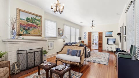Living Room: An eclectic, inviting space featuring local artwork, antique furnishings, and abundant natural light.


