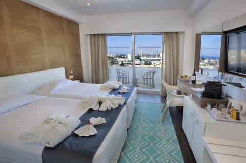 Deluxe Room, 1 Bedroom, Partial Sea View | In-room safe, desk, blackout drapes, soundproofing