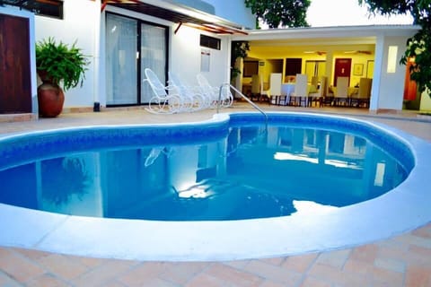 Outdoor pool, open 6:00 AM to 10:00 PM, pool umbrellas, sun loungers