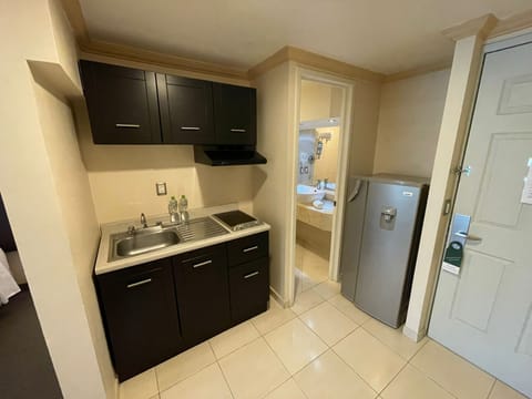 Executive Room, 2 Double Beds | Private kitchen | Full-size fridge, stovetop