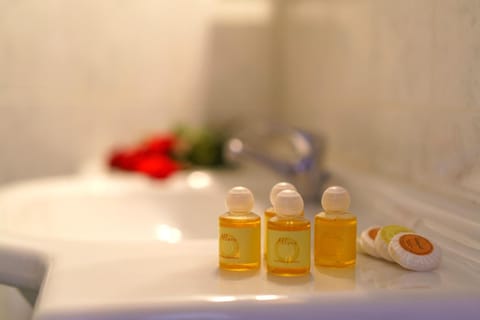 Bathtub, hair dryer, slippers, towels