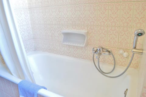 Bathtub, designer toiletries, hair dryer, towels