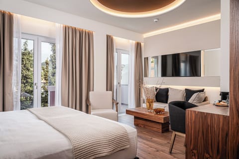 One Bedroom Junior Suite with Side Sea View | Desk, blackout drapes, iron/ironing board, free WiFi