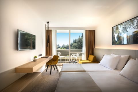 Superior Triple Room | Minibar, in-room safe, desk, blackout drapes