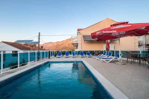 Seasonal outdoor pool, pool umbrellas, sun loungers