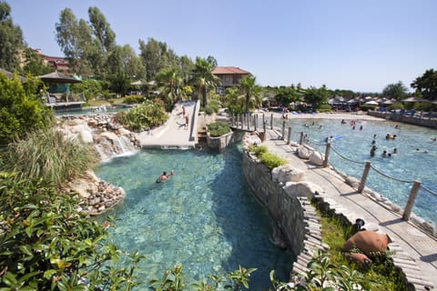 Seasonal outdoor pool, a waterfall pool, pool umbrellas, sun loungers