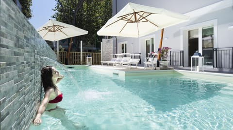 Seasonal outdoor pool, open 9:30 AM to 11:00 PM, pool umbrellas