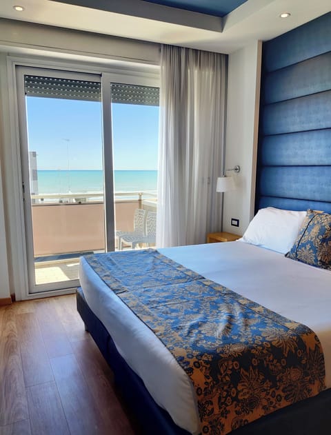 Deluxe Room, 1 Bedroom, Balcony, Sea View | Minibar, in-room safe, desk, laptop workspace