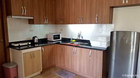 1-Bedroom Apartment at Bonbel Condominium | Private kitchen | Full-size fridge, microwave, stovetop, electric kettle