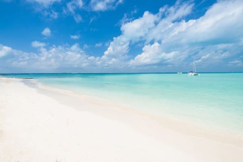 On the beach, white sand, sun loungers, beach umbrellas