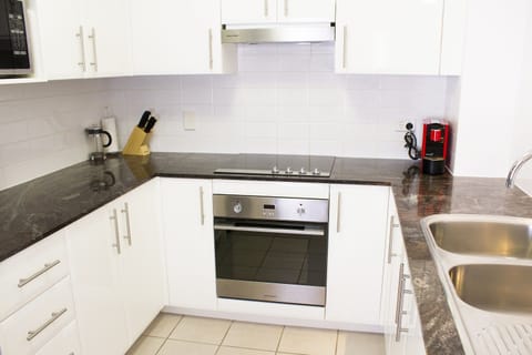 Two Bedroom | Private kitchen | Mini-fridge, microwave, toaster, cleaning supplies