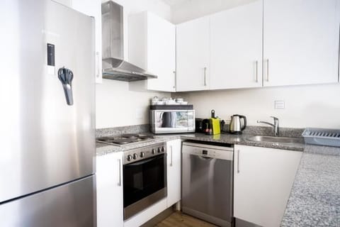 Family Apartment, Multiple Beds | Private kitchen | Full-size fridge, microwave, oven, stovetop