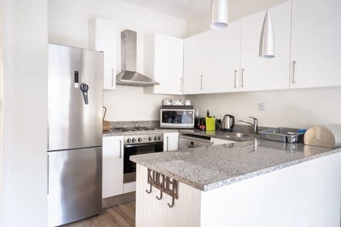 Family Apartment, Multiple Beds | Private kitchen | Full-size fridge, microwave, oven, stovetop