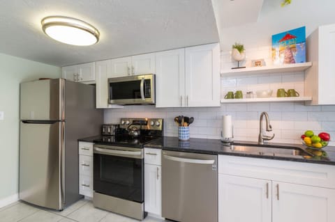 Courtyard Condo | Private kitchen | Full-size fridge, microwave, oven, stovetop