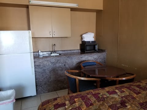 Standard Room, Multiple Beds, Non Smoking | Private kitchen | Fridge, microwave