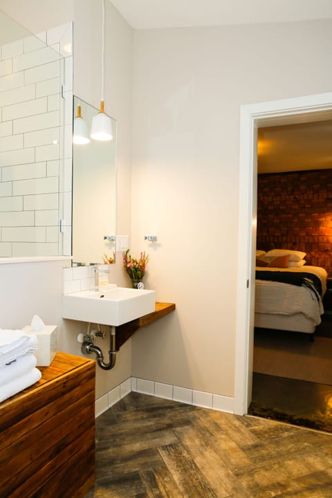 Suite, 1 King Bed with Sofa bed, Non Smoking | Bathroom | Shower, rainfall showerhead, designer toiletries, hair dryer