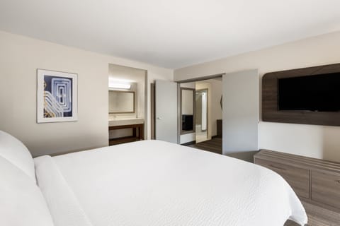 Suite, 1 King Bed, Pool View | In-room safe, desk, iron/ironing board, cribs/infant beds