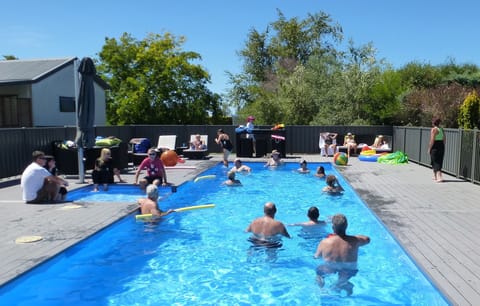 Seasonal outdoor pool, open 9:00 AM to 8:00 PM, pool umbrellas