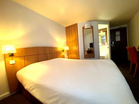 Premium bedding, desk, laptop workspace, blackout drapes